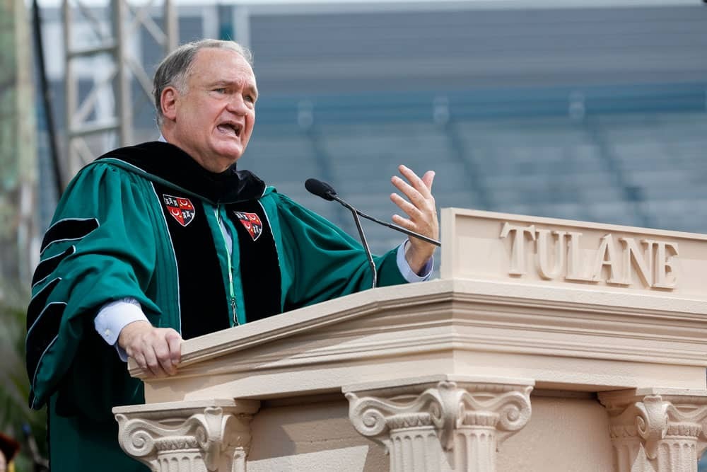 Tulane president Michael Fitts speaking at a podium during commencement