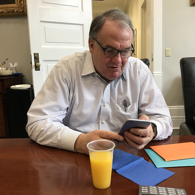 President Fitts checks his FitBit steps on his phone.